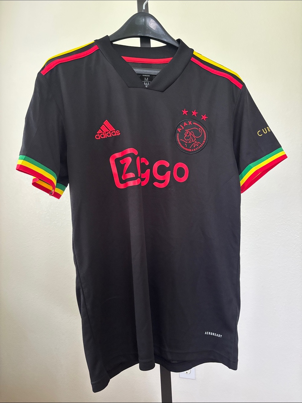 adidas Kids Black Ajax Jersey with Red Logos and Rasta Trim